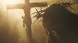 Jesus Christ with crown of thorns on his head and cross in the background