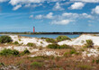 Beach sand dunes and Lighthouse Ponce de Leon Inlet in New Smyrna beach, Florida.