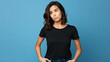 Portrait of a confused woman wearing black t-shirt . Isolated on blue background