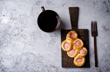 Wall Mural - Baked sausage bread Hotdog on a wood cut board