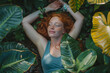 © Irina Bort - Ginger young girl lying on the ground in garden among green plants