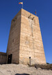 Main tower of the historic castle of Biar, Alicante, Spain, and countryside in the backyard.