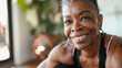Professional Portrait of an active black African American mature woman smiling and doing fitness pilates at her home gym