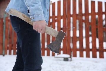 Wall Mural - Man with metal axe outdoors on winter day, closeup. Space for text