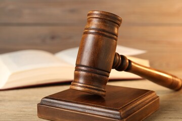 Wooden gavel and sound block on table, closeup