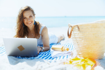 Wall Mural - happy modern woman on seashore with straw bag