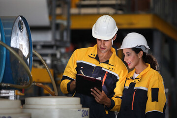 Wall Mural - worker or engineer working in factory with safety uniform , safety hat and safety glasses , image is safety concept or happy workplace