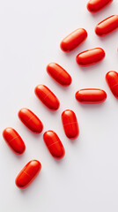Wall Mural - Red pills isolated on white background. Top view with copy space