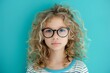 © Jelena - Portrait of a young girl with curly blonde hair wearing oversized glasses Isolated on a vibrant blue background Exuding innocence and curiosity