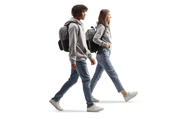 Sticker - Full length profile shot of an african american male student and a caucasian female student walking