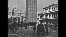 Venice, Italy - Circa 1960: Historical Restored Footage Of San Marco Square In Venice With San Marco Basilica And Bell Tower. Tourists In Typical 60s Clothes.
