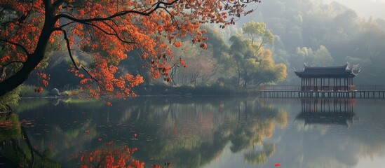 Wall Mural - Serene small bridge over tranquil lake with stunning red tree in the background