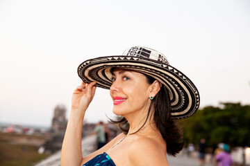 Wall Mural - Beautiful woman wearing the traditional Colombian hat called Sombrero Vueltiao at the historical streets of the Cartagena de Indias walled city