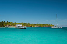 Seascape With Crystal Clear Shallow Turquoise Ocean Water, Deep Blue Sky And White Yachts And Boats On The Water Surface. Saona Island, Dominican Republic. Wide Angle Shot.