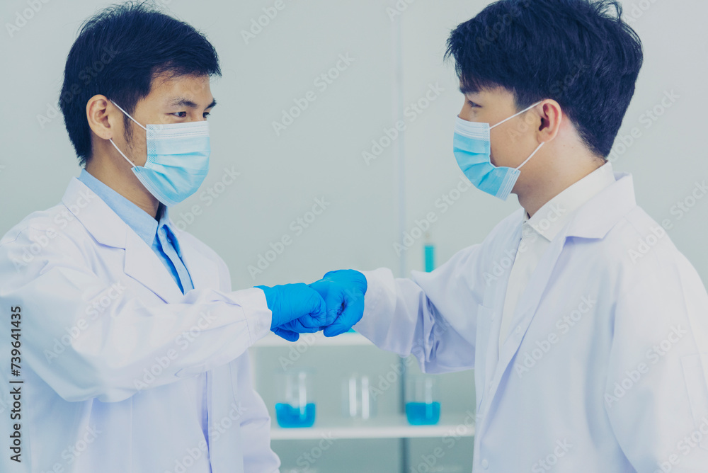 Two asian scientist men fist bump team partner shake hands together ...