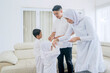 © Creativa Images - Muslim kids handshaking their parents and receive money as presents