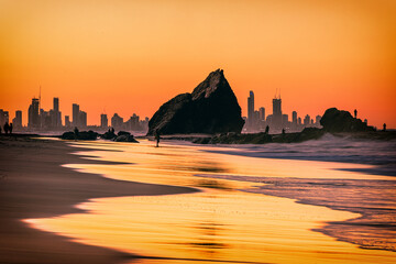 Wall Mural - The sunset view of the Currumbin Beach in the twilight and the urban skyline of  Gold Coast in the dusk