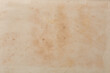 abstract of old discolored book page background, historical and vintage faded with spots or stain creamy or yellowed hue or torn, warmth and depth wallpaper or backdrop for graphic design, blank space