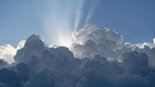 The Suns Rays Create A Spotlight Effect On A Towering Cumulus Cloud.