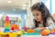 © evgenia_lo - A young girl engrossed in play with colorful toys in a children's play area at a hospital, with a cheerful and bright setting. Hospital queue