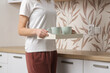 © triocean - Green ceramic tea mug on the wooden tray in the kitchen