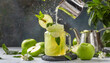 Green apple juice splash in jar and fresh apple fruit slices