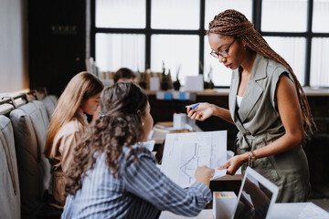 Wall Mural - People in coworking space sharing ideas, collaboring, talking about business project. Group of freelancers and remote businesspeople working in shared work area. Concept of coworking as modern working