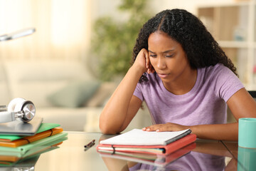 Black student studying memorizing notes at home