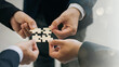 © Pcess609 - Concept of teamwork and partnership. The hands of business people join puzzle pieces together. Charity, volunteer. Unity, team business. success and strategy. togetherness Collaboration. banner