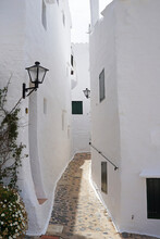 Exterior Spanish Architecture And Building Design Of The Quaint Old Fishing Village Of Binibeca Vell (Binibèquer Vell), White Houses Form A Small Labyrinth Of Narrow, Cobbled Corridors- Menorca, Spain