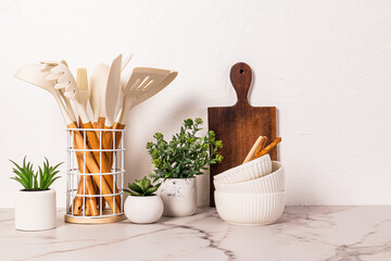 Wall Mural - Stylish kitchen background with kitchen utensils on marble white countertop. Front view. minimalism.