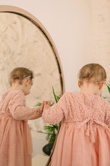 Canvas Print - cute smiling toddler girl near mirror