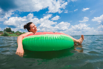 Canvas Print - happy woman chilling on inflatable pool floats