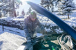 © zphoto83 - Man looking under the car hood of broken vehicle on snowy road and checking the problem.