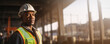 © JoelMasson - Young African American construction engineer at work with safety helmet and vest background banner
