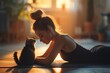Woman practicing yoga with a cat joining her on the mat in a peaceful and harmonious pose