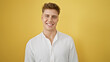 Laughing, confident young caucasian man in casual fashion, standing isolated against a yellow background, radiating positive vibes and joy