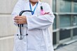 © Krakenimages.com - Young beautiful plus size woman doctor standing with arms crossed gesture holding stethoscope at hospital