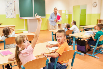 School children sitting at bench in class