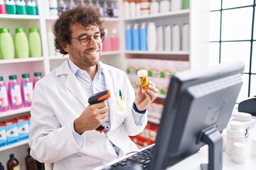 Canvas Print - Young hispanic man pharmacist scanning pills bottle at pharmacy