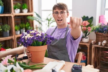 Poster - Caucasian blond man working at florist shop pointing displeased and frustrated to the camera, angry and furious with you