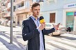 © Krakenimages.com - Young man reporter working using microphone at street