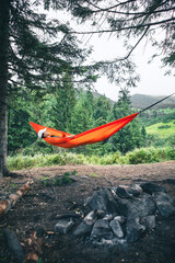 Sticker - happy woman on hammock mountains on background