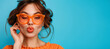 © Nataliia_Trushchenko - Portrait of beautiful young woman sending kiss on orange background. Close up photo portrait of winsome pretty cute lovely sweet glad nice lady sending kiss to you wearing orange transparent glasses