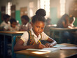 © FutureStock - Pupil girl writing at desk in classroom at the elementary school.