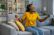 Cute young african american woman listening to music and looking happy