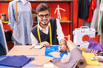 Poster - Young hispanic man tailor smiling confident make mark on cloth at atelier