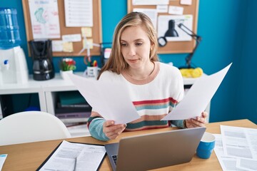 Canvas Print - Young blonde woman business worker using laptop reading document at office