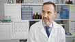 © Krakenimages.com - Serious middle age man with grey hair, a diligent scientist, engrossed in cutting-edge research at the lab, embodying the spirit of medical science and technology?