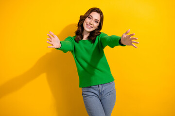 Poster - Photo of glad cheerful woman dressed trendy green clothes open hands hug come here isolated on yellow color background